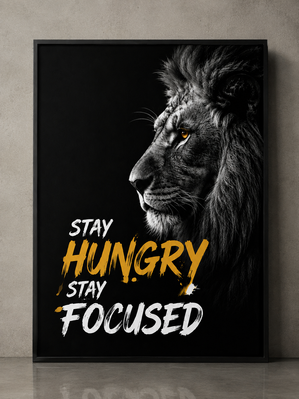 Motivational lion wall art with 'Stay Hungry Stay Focused' quote in bold yellow and white text on black background