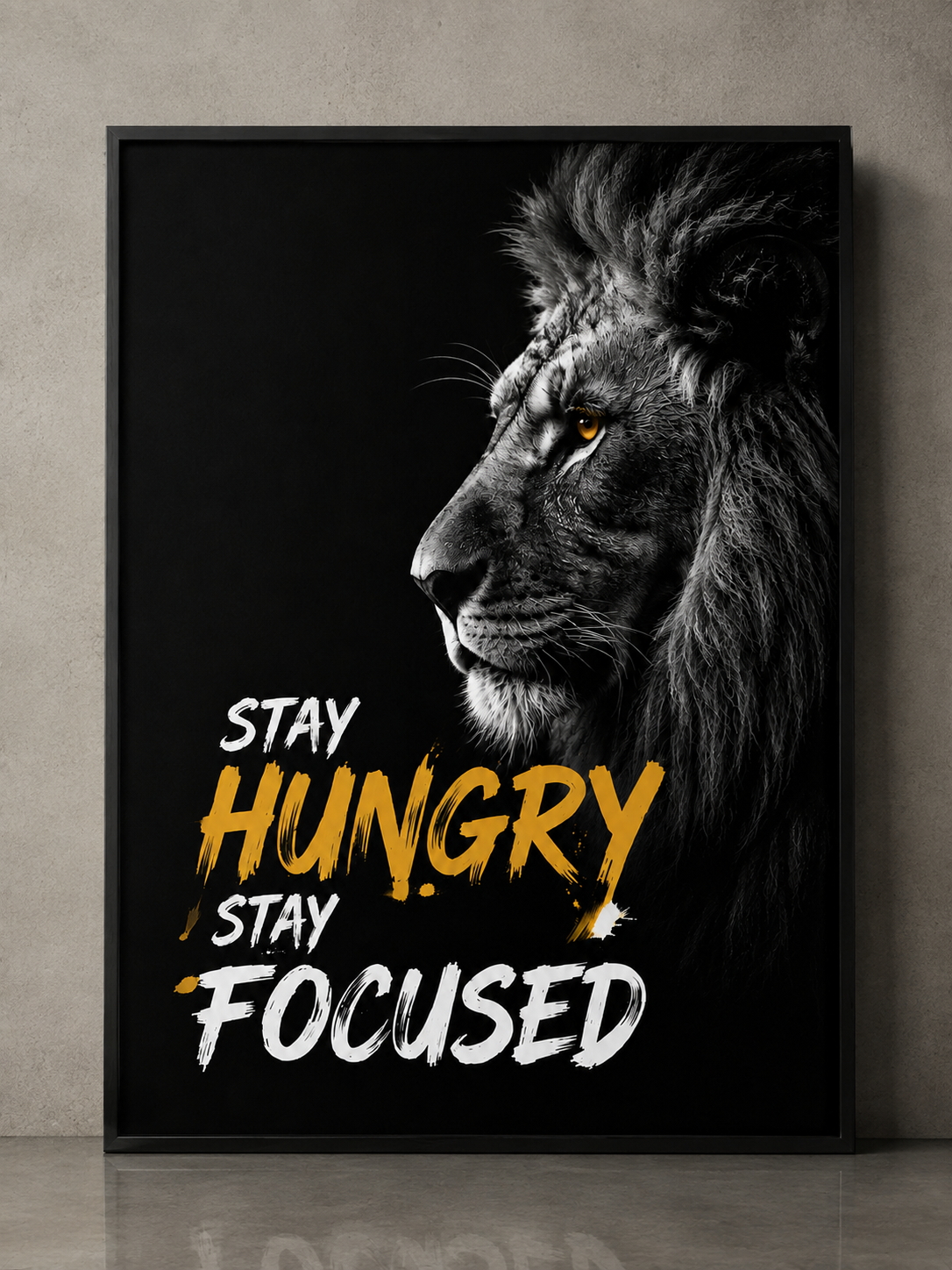 Motivational lion wall art with 'Stay Hungry Stay Focused' quote in bold yellow and white text on black background